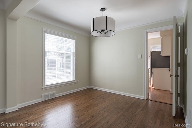 1205 S Bates St, Birmingham, MI 48009 - spare room featuring dark wood-style flooring, baseboards, crown molding, and a chandelier