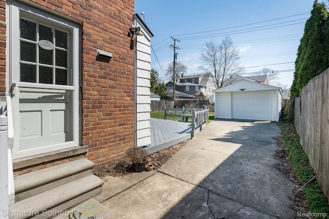 1205 S Bates St, Birmingham, MI 48009 - view of side of property featuring entry steps, brick siding, driveway, a garage, and an outbuilding