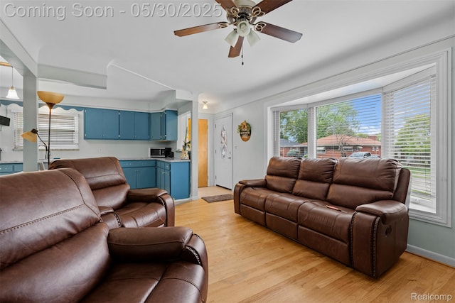 25305 Ursuline St, Saint Clair Shores, MI 48081 - living room with light wood finished floors, a ceiling fan, and baseboards