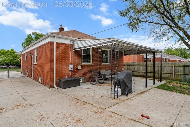 25305 Ursuline St, Saint Clair Shores, MI 48081 - rear view of property with a chimney, brick siding, and a patio