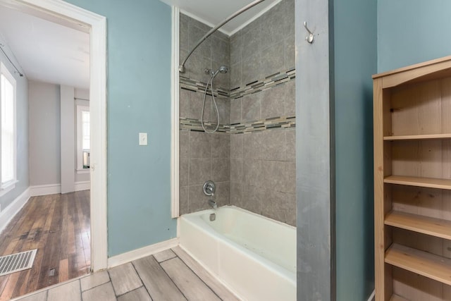 617 Wheaton Ave, Kalamazoo, MI 49008 - full bathroom with bathing tub / shower combination, baseboards, and plenty of natural light
