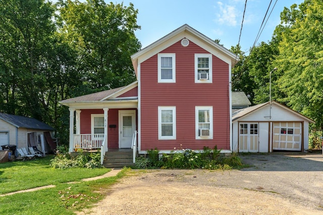 617 Wheaton Ave, Kalamazoo, MI 49008 - view of front facade with a porch, an outdoor structure, a detached garage, a front yard, and asphalt driveway