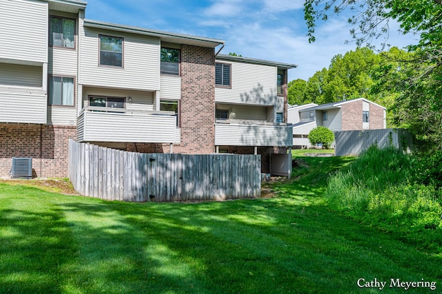 6387 Wainscot Dr SE Unit 102, Grand Rapids, MI 49546 - rear view of property with central AC, brick siding, and a lawn