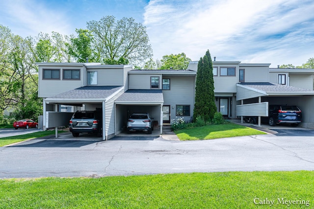 6387 Wainscot Dr SE Unit 102, Grand Rapids, MI 49546 - view of property with roof with shingles and a front yard