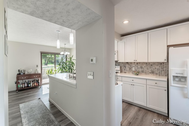 6387 Wainscot Dr SE Unit 102, Grand Rapids, MI 49546 - kitchen with white appliances, wood finished floors, white cabinets, light countertops, and recessed lighting