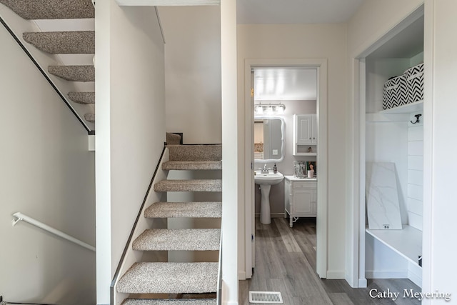 6387 Wainscot Dr SE Unit 102, Grand Rapids, MI 49546 - stairway featuring wood finished floors and baseboards