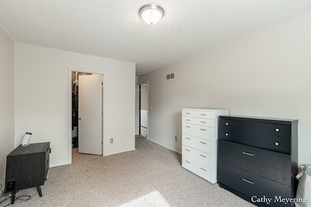 6387 Wainscot Dr SE Unit 102, Grand Rapids, MI 49546 - unfurnished bedroom with light colored carpet, a spacious closet, and baseboards