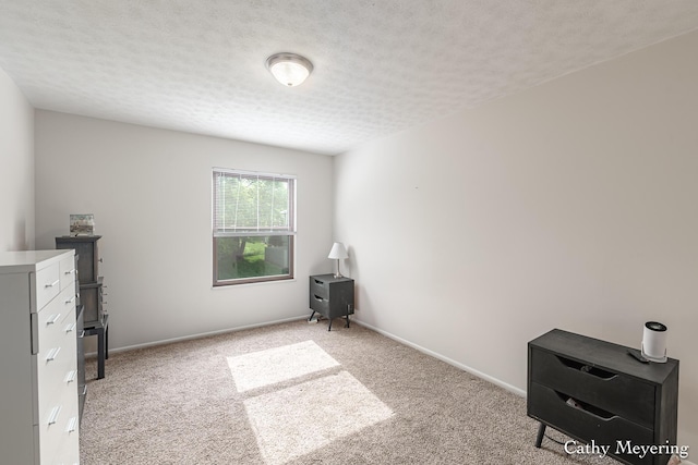 6387 Wainscot Dr SE Unit 102, Grand Rapids, MI 49546 - bedroom featuring light carpet, a textured ceiling, and baseboards