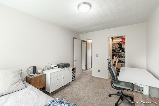 6387 Wainscot Dr SE Unit 102, Grand Rapids, MI 49546 - bedroom with an office area, light colored carpet, a walk in closet, a closet, and a textured ceiling