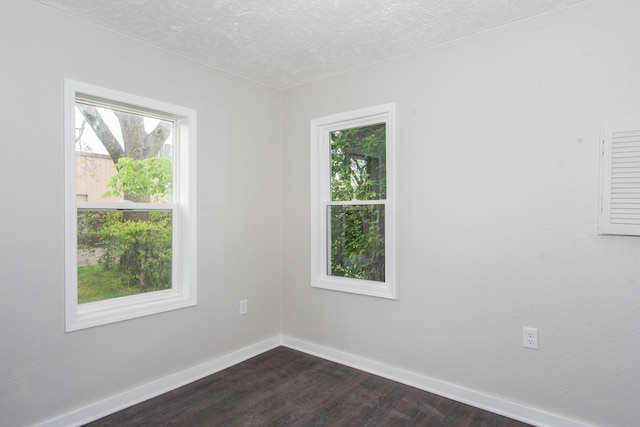 1226 Shakespeare Ave, Kalamazoo, MI 49001 - empty room with dark wood-type flooring, baseboards, and a textured ceiling