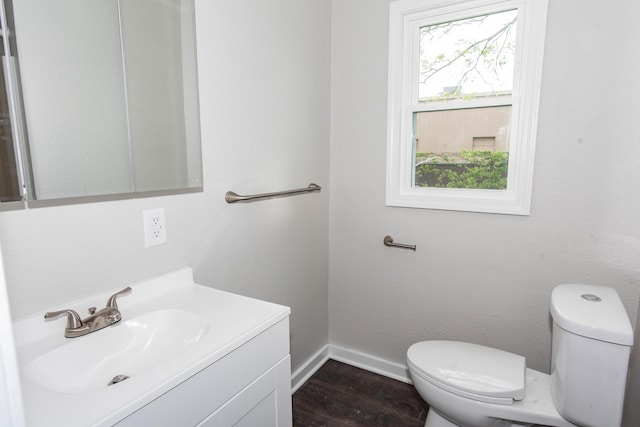 1226 Shakespeare Ave, Kalamazoo, MI 49001 - half bath with toilet, vanity, baseboards, and wood finished floors