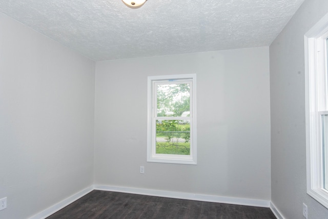 1226 Shakespeare Ave, Kalamazoo, MI 49001 - empty room featuring dark wood-type flooring, a textured ceiling, and baseboards