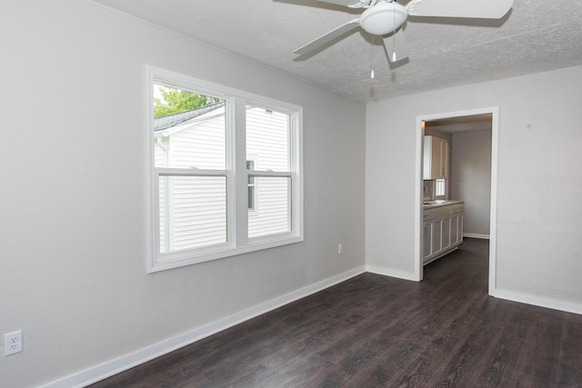 1226 Shakespeare Ave, Kalamazoo, MI 49001 - spare room featuring dark wood finished floors, baseboards, and ceiling fan