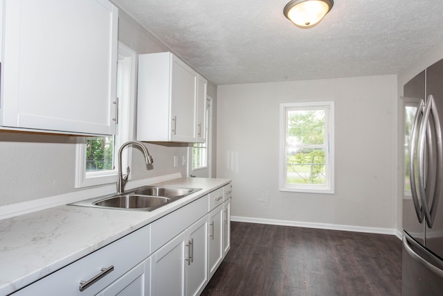 1226 Shakespeare Ave, Kalamazoo, MI 49001 - kitchen featuring a sink, freestanding refrigerator, dark wood-style floors, white cabinets, and baseboards