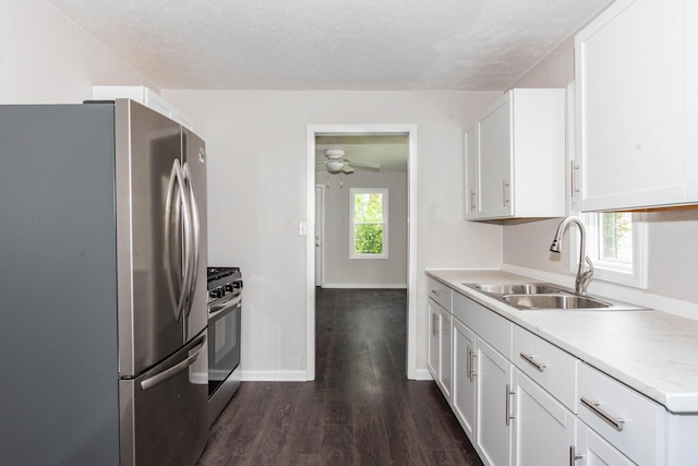 1226 Shakespeare Ave, Kalamazoo, MI 49001 - kitchen featuring appliances with stainless steel finishes, a sink, dark wood finished floors, light countertops, and white cabinets