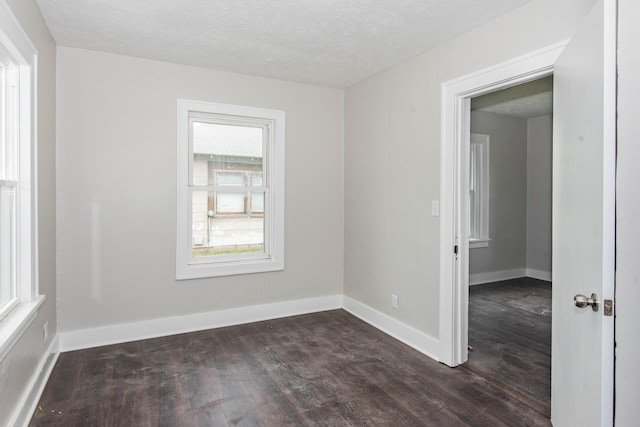 1226 Shakespeare Ave, Kalamazoo, MI 49001 - spare room featuring dark wood-type flooring, baseboards, and a textured ceiling