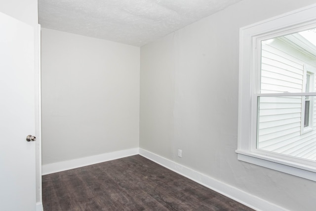 1226 Shakespeare Ave, Kalamazoo, MI 49001 - unfurnished room featuring dark wood finished floors, a textured ceiling, and baseboards