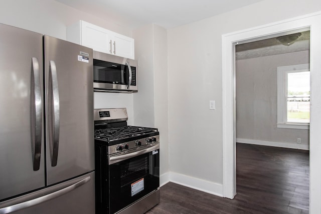 1226 Shakespeare Ave, Kalamazoo, MI 49001 - kitchen featuring stainless steel appliances, baseboards, dark wood finished floors, and white cabinets