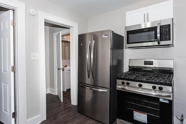 1226 Shakespeare Ave, Kalamazoo, MI 49001 - kitchen with stainless steel appliances, dark wood-style flooring, white cabinetry, and baseboards