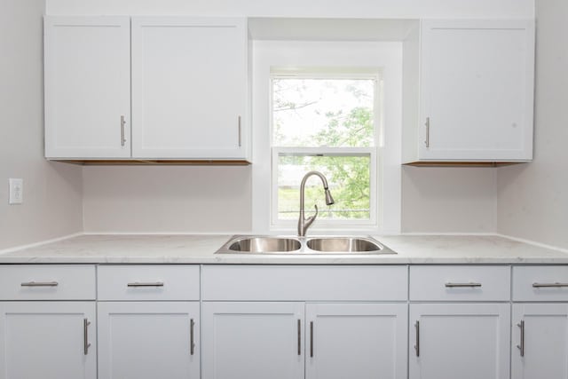 1226 Shakespeare Ave, Kalamazoo, MI 49001 - kitchen featuring a sink, white cabinetry, and light stone countertops