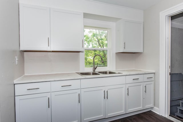 1226 Shakespeare Ave, Kalamazoo, MI 49001 - kitchen featuring a sink, white cabinets, dark wood finished floors, and light stone counters