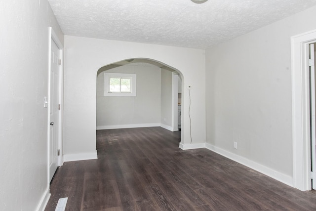 1226 Shakespeare Ave, Kalamazoo, MI 49001 - unfurnished room featuring arched walkways, wood finished floors, a textured ceiling, and baseboards
