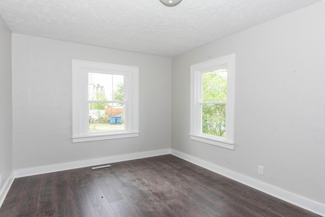1226 Shakespeare Ave, Kalamazoo, MI 49001 - spare room with dark wood-style floors, a textured ceiling, and baseboards