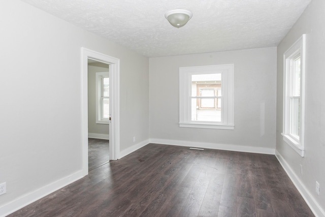 1226 Shakespeare Ave, Kalamazoo, MI 49001 - unfurnished room with a textured ceiling, dark wood finished floors, and baseboards