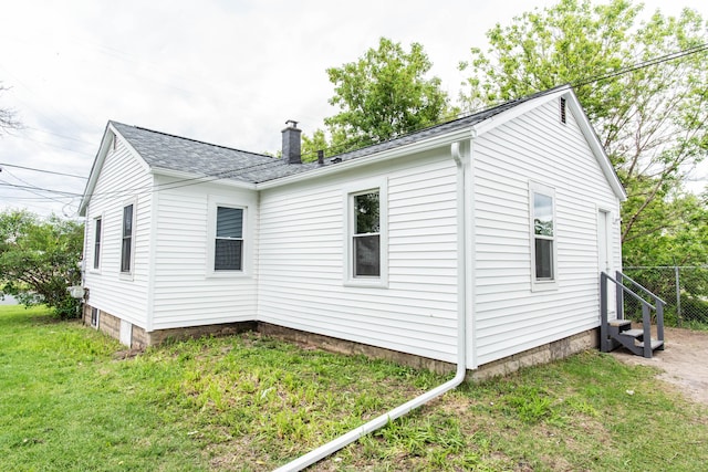 1226 Shakespeare Ave, Kalamazoo, MI 49001 - view of home's exterior with a chimney, entry steps, and roof with shingles