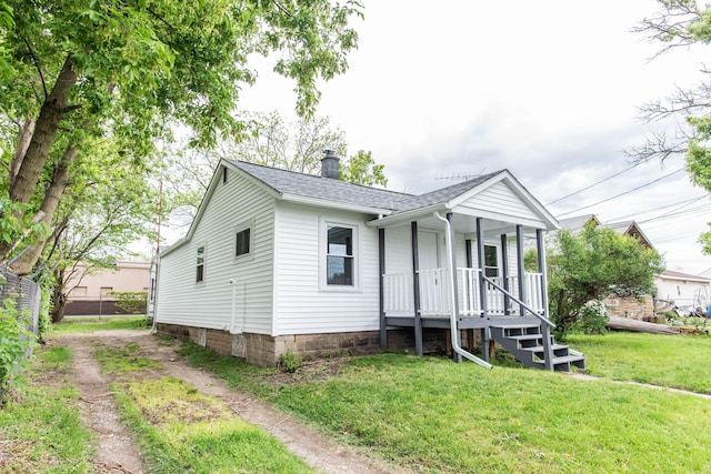 1226 Shakespeare Ave, Kalamazoo, MI 49001 - view of front of house with a porch, a chimney, a front yard, and a shingled roof