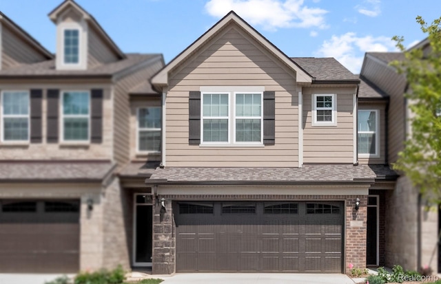 103 Addison Cir, Walled Lake, MI 48390 - townhome / multi-family property with a garage and driveway