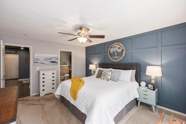 4465 Spinnaker Ln, Pleasant Lake, MI 49272 - carpeted bedroom featuring a decorative wall, a ceiling fan, baseboards, and ensuite bath