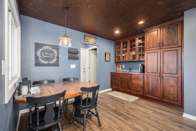 4465 Spinnaker Ln, Pleasant Lake, MI 49272 - dining space featuring baseboards, wood finished floors, and recessed lighting