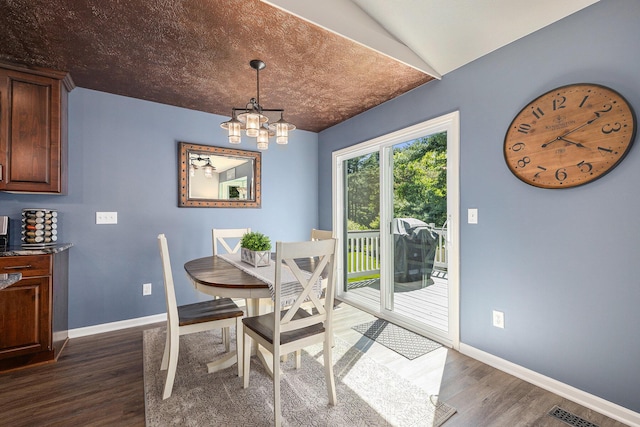 4465 Spinnaker Ln, Pleasant Lake, MI 49272 - dining space featuring dark wood finished floors, baseboards, and a chandelier