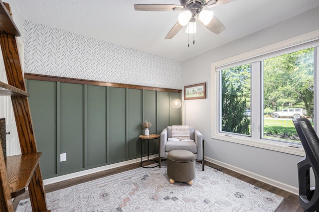4465 Spinnaker Ln, Pleasant Lake, MI 49272 - living area with wallpapered walls, baseboards, wood finished floors, an accent wall, and ceiling fan