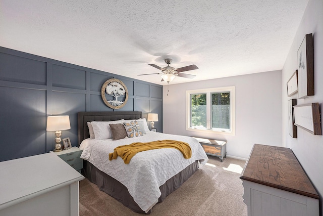 4465 Spinnaker Ln, Pleasant Lake, MI 49272 - bedroom with carpet floors, ceiling fan, a decorative wall, a textured ceiling, and baseboards