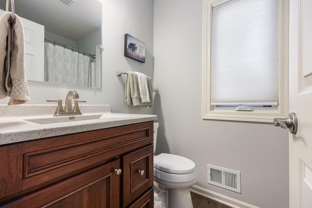 4465 Spinnaker Ln, Pleasant Lake, MI 49272 - bathroom with vanity, toilet, wood finished floors, and baseboards