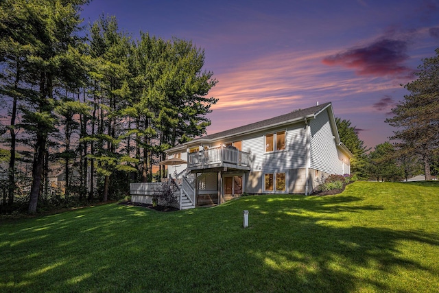 4465 Spinnaker Ln, Pleasant Lake, MI 49272 - back of property at dusk with stairs, a wooden deck, and a lawn