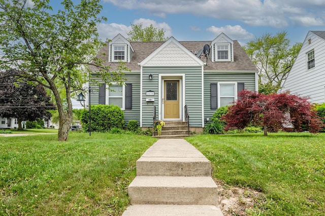 2630 Willa Dr, Saint Joseph, MI 49085 - view of front of house with entry steps, a front yard, and a shingled roof