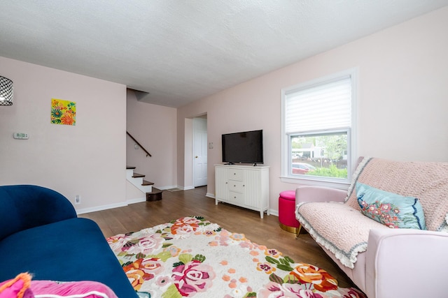 2630 Willa Dr, Saint Joseph, MI 49085 - living room featuring stairs, wood finished floors, and baseboards