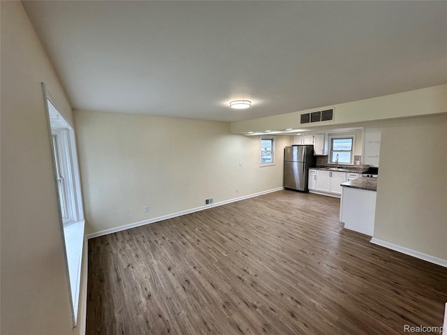 33050 John Hauk St, Garden City, MI 48135 - unfurnished living room with a sink, dark wood-style floors, and baseboards
