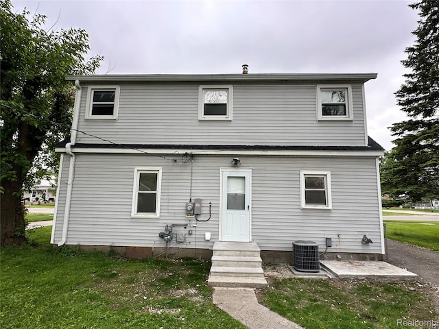 33050 John Hauk St, Garden City, MI 48135 - rear view of house featuring central air condition unit, entry steps, and a yard