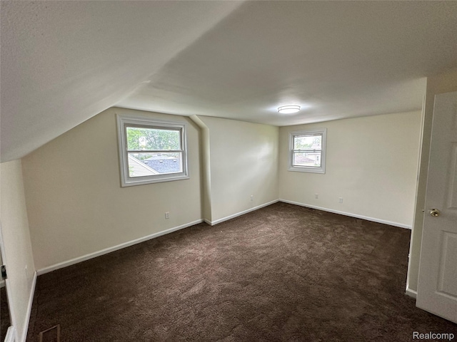 33050 John Hauk St, Garden City, MI 48135 - bonus room with dark colored carpet, vaulted ceiling, and baseboards