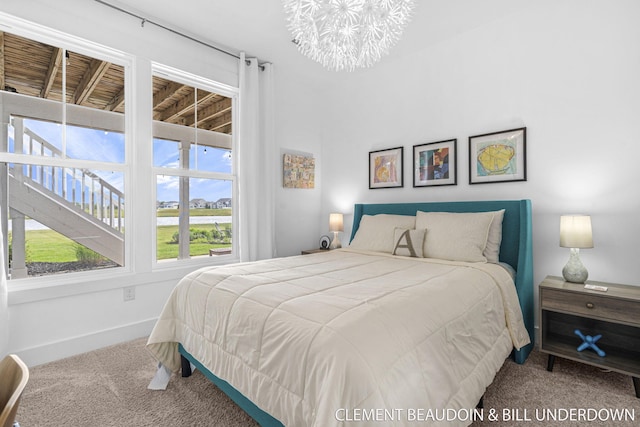 13944 Harrington Lndg, Holland, MI 49424 - carpeted bedroom featuring a chandelier and baseboards