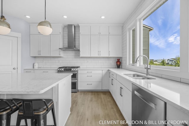 13944 Harrington Lndg, Holland, MI 49424 - kitchen featuring wall chimney range hood, appliances with stainless steel finishes, a sink, backsplash, and recessed lighting