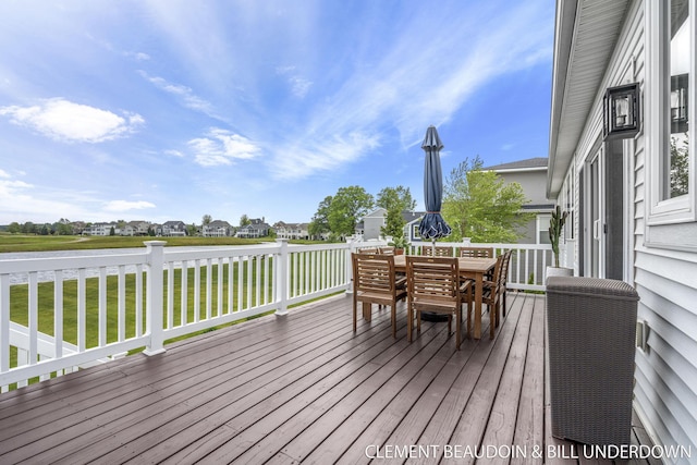 13944 Harrington Lndg, Holland, MI 49424 - wooden deck featuring outdoor dining space, a water view, and a lawn