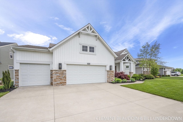 13944 Harrington Lndg, Holland, MI 49424 - craftsman inspired home with board and batten siding, driveway, a front yard, an attached garage, and stone siding