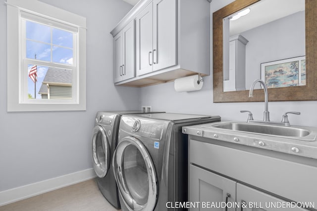 13944 Harrington Lndg, Holland, MI 49424 - laundry area with separate washer and dryer, cabinet space, and baseboards