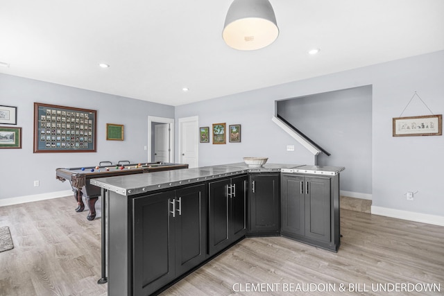 13944 Harrington Lndg, Holland, MI 49424 - kitchen with light wood finished floors, dark cabinets, a kitchen island, baseboards, and billiards