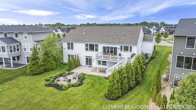 13944 Harrington Lndg, Holland, MI 49424 - back of property featuring a patio, a residential view, an outdoor fire pit, and a yard